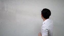 Young Asian foreign oriental language instructor giving a language lesson in classroom - Asian language education concept such as Japanese, Korean, Chinese  - Characters on the board are Chinese and Hello in Chinese Stock Footage