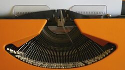 High and side angle footage of a person writing ISLAMOPHOBIA on a typewriter, with sound Stock Footage