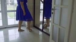 Fat girl in a blue dress in front of a mirror Stock Footage