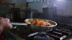 chef cooking or tosses spaghetti seafood in a frying pan. Slow motion. Stock Footage