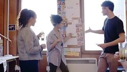 Creative designers discussing photographs in office meeting Stock Footage