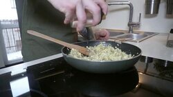 Hands of young man sprinkling salt on scrambled eggs Stock Footage