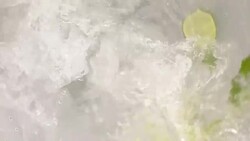 Water swirling with lime and mint slow motion Stock Footage