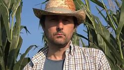 Portrait of pensive serious farmer in corn field Stock Footage