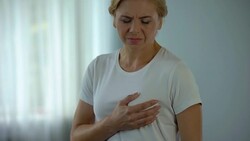 Middle-aged woman feeling chest pain, ischemic disease and cardiology, health Stock Footage