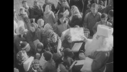 Santa Claus passes out gifts to American and Korean children in Korea, December 1954 News Clip