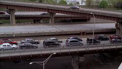 PAN RIGHT TO LEFT OF CARS IN TRAFFIC ON FREEWAY OR HIGHWAY. Stock Footage