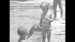 A woman and child at a swimming pool in the 1930s News Clip