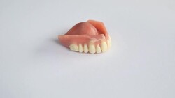 Dentures on a rotating white plate Stock Footage