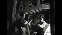 Men playing instruments and singing in barn, 1940s Stock Footage