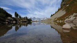 Time lapse of lake Spiegelsee (Mirror Lake) with reflections of the Dachstein mountains. Reiteralm, Schladming-Dachstein, Austria. Stock Footage
