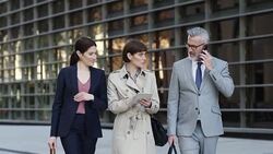 Business people with technologies on sidewalk Stock Footage