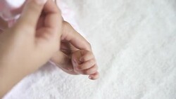 Put infant hand gloves by parent. Stock Footage