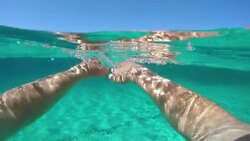 POV: Young male tourist swimming towards the sunny shores of beautiful Sardinia. Stock Footage