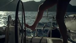 Woman steers the yacht with leg Stock Footage
