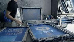 Fashion designers screen t-shirt, working at workspace Stock Footage