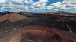 Aerial panorama of volcanic valley in Timanfaya National Park and Montana Blanca, Lanzarote, Canary islands, Spain Stock Footage