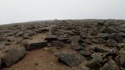 Walking towards mountain peak, summit on Cairn Gorm mountain, Scotland Stock Footage