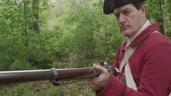 Revolutionary War soldier lifting long musket barrel Stock Footage