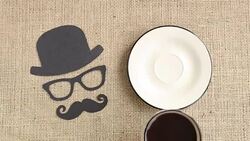 Male silhouette pattern with mustache, glasses and hat with cup of coffee on the burlap background. Movember concept. Prostate Cancer and men's health awareness Stock Footage