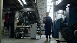 Engineer Carrying Rolled Blueprints through Building Stock Footage