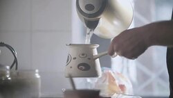 Man Pouring  Hot Water In A Turkish Coffee Pot Stock Footage
