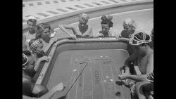 Men and women in the Las Vegas Sands Hotel swimming pool playing craps and blackjack in the 1950s News Clip
