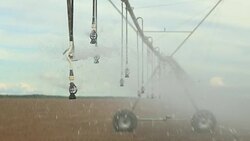 Pivot sprinkler system irrigating crops. Irrigation pivot system watering agriculture field in 4K 60fps Stock Footage