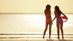 Happy African American Asian Chinese girls on beach Stock Footage