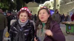 The faithful keep concerns aside to celebrate Christmas News Clip