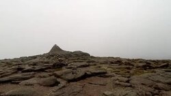 Walking towards mountain peak, summit on Cairn Gorm mountain, Scotland Stock Footage