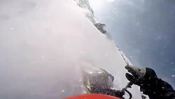 Man falling from a snowmobile in the mountains Stock Footage