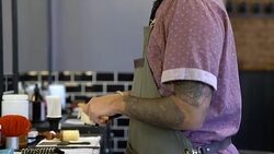 Barber cleaning electric razor with brush in salon Stock Footage