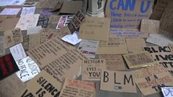 Placards left at the plinth where Edward Colstons statue once stood News Clip