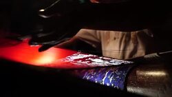 Craftsman working on huge old wooden brocade weaving looms Stock Footage