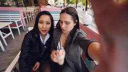 Point of view shot of good-looking young women taking selfie is cafe sitting at table with cocktails drinking and posing having fun and hugging. People, drinks and photos concept. Stock Footage