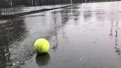 Raining on tennis court Stock Footage