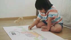 Boy is drawing and crayon of dinosaur Stock Footage