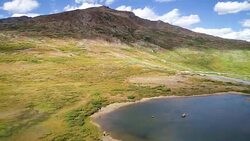 Rocky Mountain Fly over High Alpine Lake above Independence Pass near Aspen , Colorado in the Elk Mountain Range Stock Footage