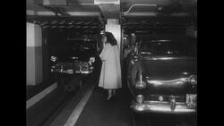 United States, c.1951: An elevator brings a car down from a garage to its waiting owner Stock Footage