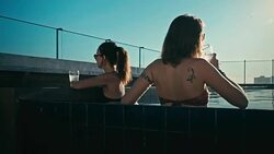 young sexy woman girls enjoying a drink in a luxurious flat water pool Stock Footage