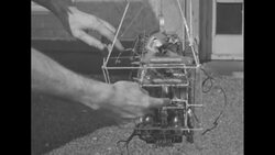 Men at Swarthmore College perform research on cosmic rays with transmitter and cellophane balloon News Clip