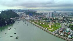 4k Aerial view over city and park with Bai Tho karst mountain Ha long bay. Halong City. Stock Footage
