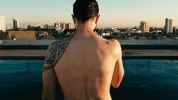 young man jumping to the rooftop pool above the city Stock Footage