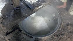 close up on a man pressing rice dough; Rice noodles are cooked in boiling water straightaway Stock Footage