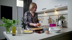 Young woman peeling and cutting onion Stock Footage