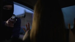 Carjacker threatening female victim with pistol, robber stealing automobile Stock Footage