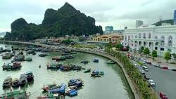 4k Aerial view over city and park with Bai Tho karst mountain Ha long bay. Halong City. Stock Footage