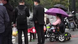 CLEAN : China wheelchair users dodge traffic on road to recognition News Clip