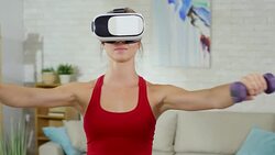 Woman in VR Goggles Using Dumbbells Stock Footage